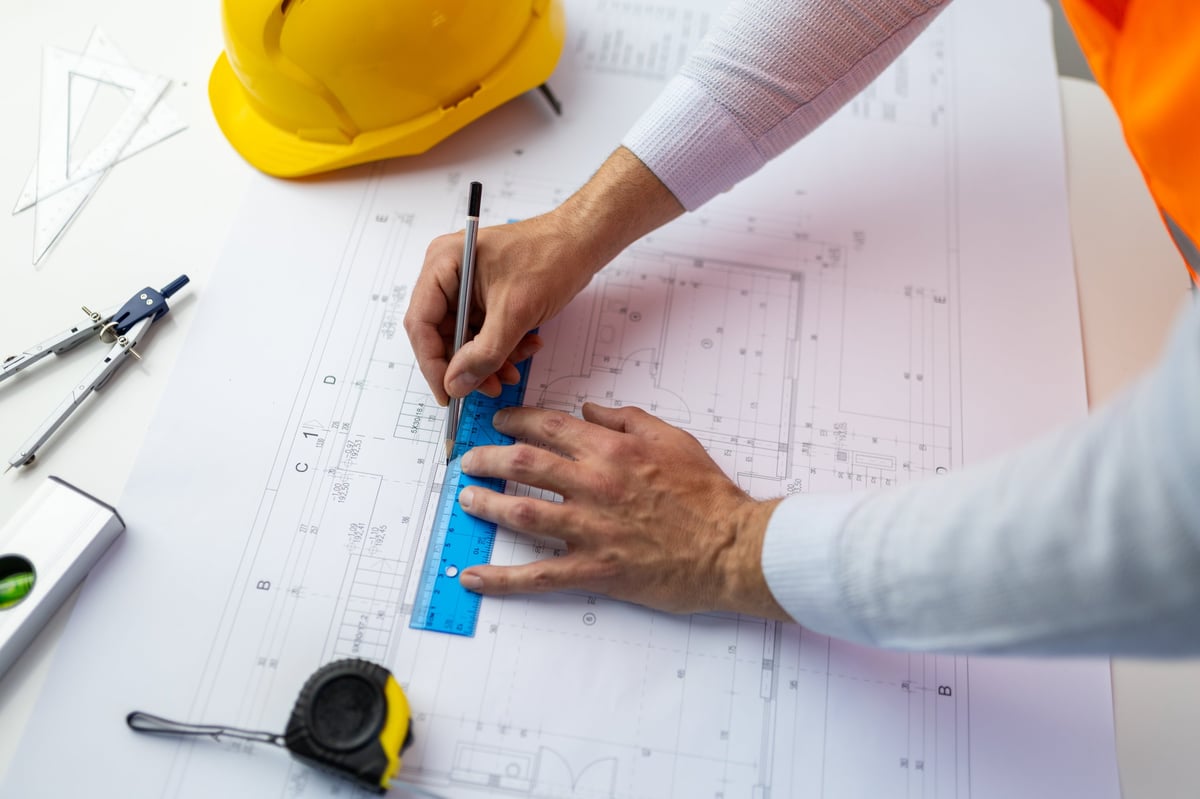 Planning drawings and site documentation on a desk